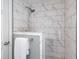 Modern shower featuring sleek marble tiling, a rainfall shower head, and convenient towel rack at 106 N Trail Dr, Raleigh, NC 27615