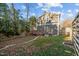 A backyard with a privacy fence, deck and low-maintenance artificial turf at 107 Bond St, Durham, NC 27707