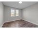 Small bedroom with wood-look floors and natural light from the double windows at 107 Bond St, Durham, NC 27707