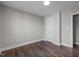 Bright bedroom with wood-look flooring, white trim, and a large closet at 107 Bond St, Durham, NC 27707