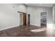 Spacious bedroom features hardwood floors, neutral walls, and sliding barn door to attached bath at 107 Bond St, Durham, NC 27707
