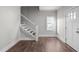 Foyer features a staircase, hardwood floors, and a window bringing in lots of natural light at 107 Bond St, Durham, NC 27707