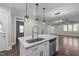 A modern kitchen island featuring white cabinets, stainless steel appliances and a sleek design at 107 Bond St, Durham, NC 27707
