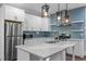 Well-equipped kitchen with stainless appliances, quartz countertops, and striking subway tile backsplash at 107 Bond St, Durham, NC 27707