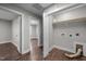 Bright laundry area with washer hookups, wooden-look vinyl flooring, and an open doorway at 107 Bond St, Durham, NC 27707