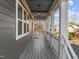 View of the cozy front porch with hanging lights and wooden flooring at 107 Bond St, Durham, NC 27707