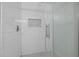 Shower with large glass door and white brick tile plus niche with decorative tile at 107 Bond St, Durham, NC 27707