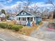 Quaint blue home showcasing a welcoming porch and well-maintained yard at 107 S 3Rd St, Sanford, NC 27330