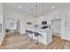 Modern kitchen featuring an island with barstool seating, pendant lighting, and stainless steel appliances at 107 S 3Rd St, Sanford, NC 27330