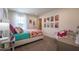 Bedroom with decorative chair, carpeted floor, and a colorful floral bed at 110 Cribbs Ln, Middlesex, NC 27557