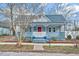 Charming cottage-style home with a covered front porch and a vibrant pink front door at 118 S Guthrie Ave, Durham, NC 27703