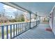 Inviting covered front porch with blue accents, ideal for relaxing outdoors and enjoying the neighborhood view at 118 S Guthrie Ave, Durham, NC 27703