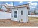 Small shed with door and window sits in the backyard, adjacent to a white fence at 118 S Guthrie Ave, Durham, NC 27703