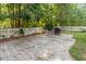 Spacious brick backyard patio featuring an outdoor fireplace, ideal for social events and gatherings at 1230 Auburn Village Drive Dr, Durham, NC 27713