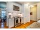 Modern kitchen featuring stainless steel oven and hood, complemented by granite countertops and white tile backsplash at 1243 Great Ridge Pkwy, Chapel Hill, NC 27516