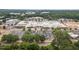 Aerial view of a shopping center surrounded by trees, with parking and easy access to nearby amenities at 130 S Estes Dr # G3, Chapel Hill, NC 27514