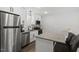 Modern kitchen with white cabinets, stainless steel appliances and granite island at 130 S Estes Dr # G3, Chapel Hill, NC 27514