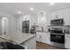 Modern kitchen with white cabinetry, stainless steel appliances, and a stylish island at 130 S Estes Dr # G3, Chapel Hill, NC 27514