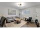 Cozy living room with wood flooring, a gray couch, and neutral decor at 130 S Estes Dr # G3, Chapel Hill, NC 27514