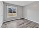 The bedroom has wood-look plank floors, gray walls, white trim, and a window at 140 Old Grapevine Rd, Kenly, NC 27542