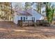 The backyard of this cozy home features mature trees, a patio and manicured landscaping at 144 Loblolly Ln, Chapel Hill, NC 27516