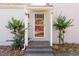 Inviting front entrance showcasing a storm door and small covered porch area with space for potted plants at 144 Loblolly Ln, Chapel Hill, NC 27516