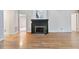 Spacious living room showcasing hardwood floors and a traditional fireplace with a dark wood mantle at 144 Loblolly Ln, Chapel Hill, NC 27516