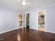 Bedroom featuring hardwood floors with multiple access points to other rooms and closet space at 18 Wedgewood Ct, Chapel Hill, NC 27514