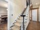 Carpeted staircase with white railing and access to the main level of the house at 18 Wedgewood Ct, Chapel Hill, NC 27514