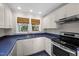 Well-lit kitchen with stainless steel appliances and white cabinets at 1813 University Dr, Durham, NC 27707