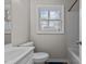 Bright bathroom features a large window, white fixtures, and neutral wall color at 200 Westbury Dr, Oxford, NC 27565