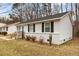 Charming house with white vinyl siding, black shutters, and a front yard at 200 Westbury Dr, Oxford, NC 27565