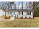 Charming one-story home with a blue front door and well-maintained landscaping at 200 Westbury Dr, Oxford, NC 27565