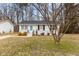 Quaint one-story home featuring a bright blue front door and black window shutters at 200 Westbury Dr, Oxford, NC 27565