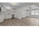 Open floor plan featuring kitchen with white cabinets, stainless steel dishwasher, and light wood flooring at 200 Westbury Dr, Oxford, NC 27565