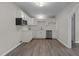 Bright kitchen with white cabinets, light wood floors, stainless steel appliances, and subway tile backsplash at 200 Westbury Dr, Oxford, NC 27565