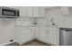 Bright kitchen featuring white cabinets, quartz countertops, and stainless steel appliances at 200 Westbury Dr, Oxford, NC 27565