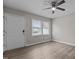 Bright living room with ceiling fan, front door, large windows, and light wood flooring at 200 Westbury Dr, Oxford, NC 27565
