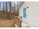 Side entrance with a white door and wood railing at 200 Westbury Dr, Oxford, NC 27565