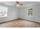 Bright bedroom with hardwood floors and two windows at 2001 Rolesville Rd, Wake Forest, NC 27587