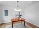 Dining room featuring a modern light fixture, a view into the kitchen, and neutral colors at 2001 Rolesville Rd, Wake Forest, NC 27587