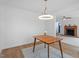 Bright dining room featuring a modern light fixture and an open view into the living room at 2001 Rolesville Rd, Wake Forest, NC 27587