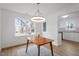 Bright dining room featuring a modern light fixture and large windows overlooking a backyard at 2001 Rolesville Rd, Wake Forest, NC 27587