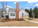 Charming bungalow featuring a brick chimney and blue front door at 2001 Rolesville Rd, Wake Forest, NC 27587