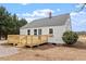 Well-maintained home featuring a deck, tidy landscaping, and blue door at 2001 Rolesville Rd, Wake Forest, NC 27587