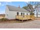 Back of home featuring a deck, manicured lawn, and gray roof at 2001 Rolesville Rd, Wake Forest, NC 27587