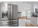 Stainless steel refrigerator in updated kitchen with wood countertops and white cabinets at 2001 Rolesville Rd, Wake Forest, NC 27587