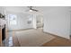 Bright living room featuring a large window, a ceiling fan, and a modern rug at 2001 Rolesville Rd, Wake Forest, NC 27587