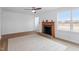 Living room featuring a ceiling fan, a fireplace, and a large window for natural light at 2001 Rolesville Rd, Wake Forest, NC 27587