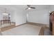 Bright living room featuring a ceiling fan and a fireplace open to the dining area at 2001 Rolesville Rd, Wake Forest, NC 27587